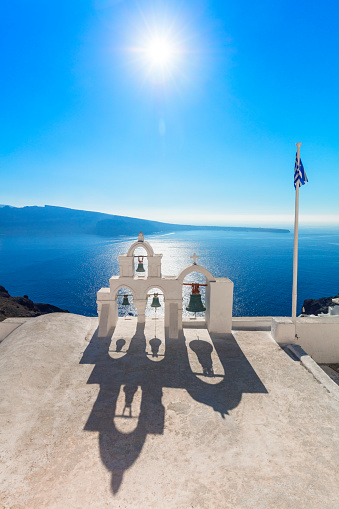 Santorini, Greece. Minimalistic composition traditional architecture of Santorini island. White arches with domes against the background of the blue sea, a beautiful shadow on a sunny day. Greece, Santorini, Oia
