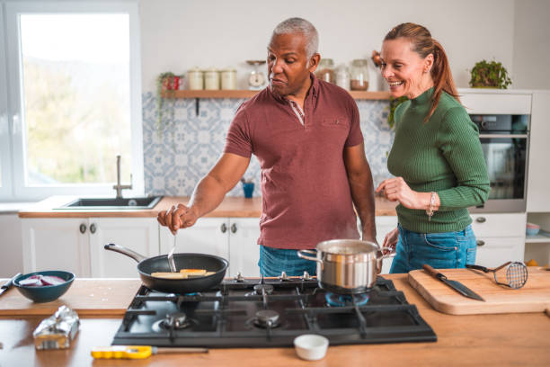 istock Mature Diverse Couple Sharing Their Love For Cooking 1584388812
