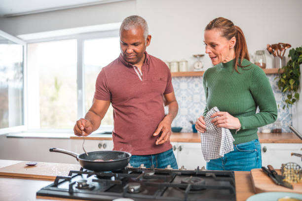 istock Attractive Mature Couple Cooking With Love 1584388916
