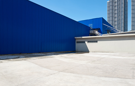 Minimalist composition of dark blue iron wall and concrete floor urban background