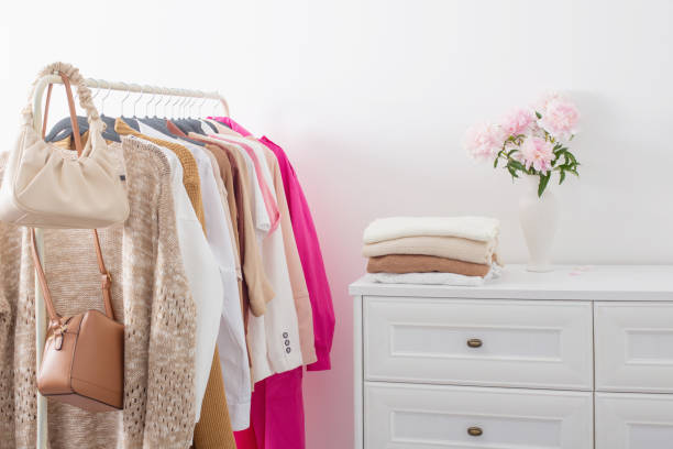 istock female clothes on hangers  in  white room 1584431646