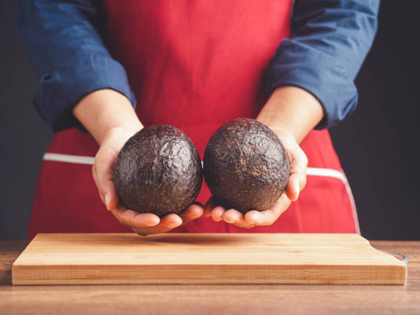 istock The chef hands holding a fresh two avocado while standing in the kitchen 1584467662