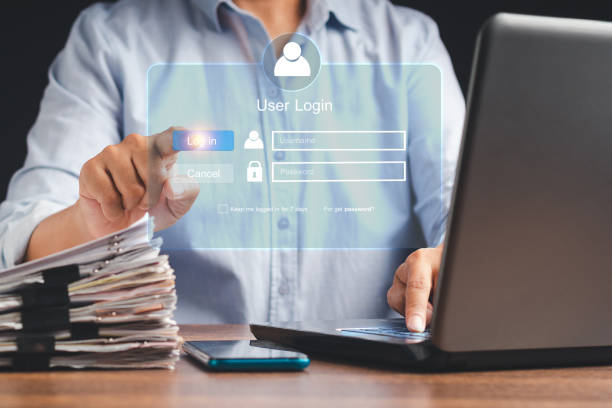 istock Businessman touching login button to the network system on a virtual screen 1584482093