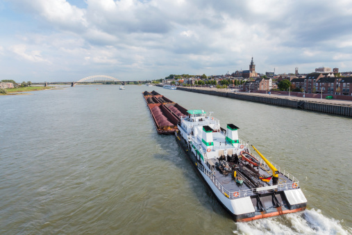 Cargo riverboat passing the Dutch city Nijmegen on the river Waal