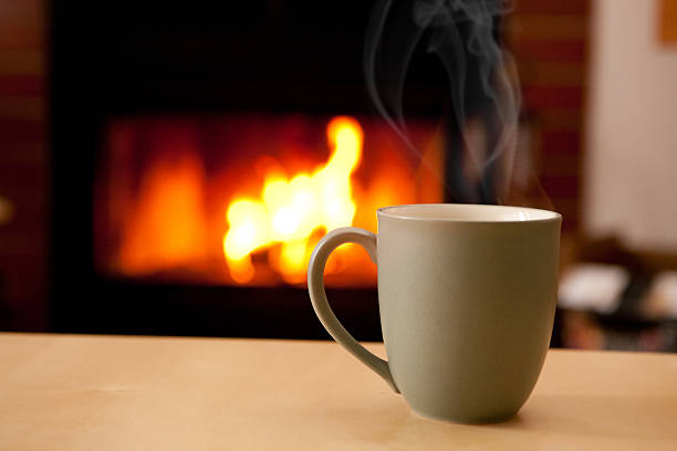 istock Hot Cup of Coffee Against Fireplace 158451693