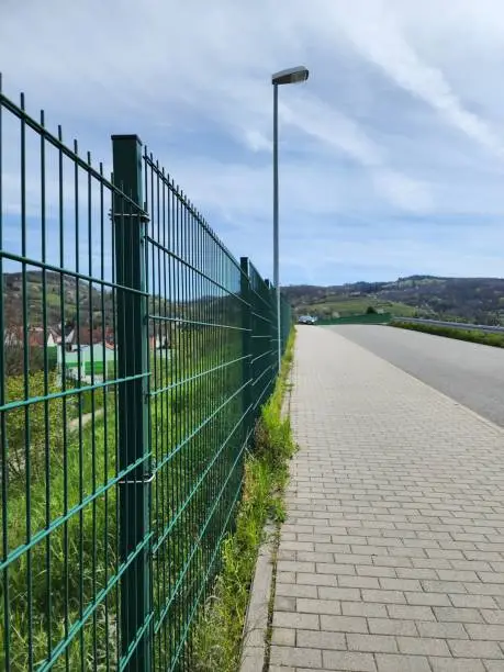 Photo of green wire mesh fence is commonly used to block the area The territory is simple, easy to set up and strong.