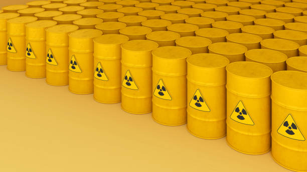 istock Radioactive storage tanks with a warning for chemical and radiation risks on a yellow backdrop.,3d rendering 1584555339