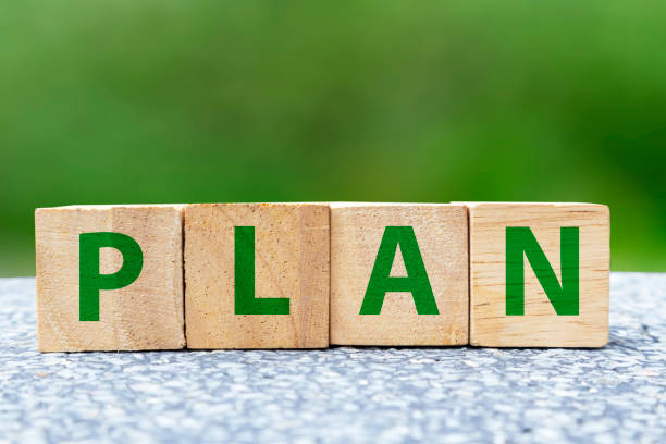 istock plan on wooden box on green background,Doing business must have a plan to work towards the goal. 1584564904