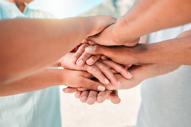 istock People, trust and hands together for teamwork, agreement or collaboration in solidarity outdoors. Community, group or gathering piling or touching hand for unity, celebration or love in partnership 1584595329