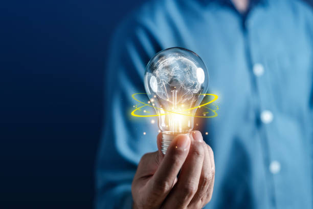 hand man holding illuminated lightbulb, idea, global innovation and inspiration with glowing virtual brain, smart intelligent creativity with bulbs, motivation and innovation concept. - growth global business global communications healthcare and medicine imagens e fotografias de stock