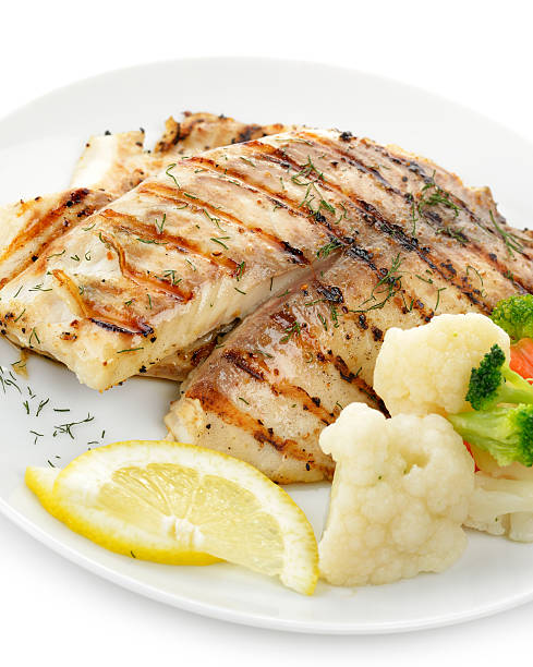 istock Close-up of dinner plate with grilled fish and vegetables 158462257