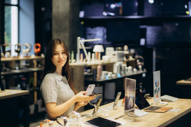 istock Side view of woman using smart phone in store 1584624764
