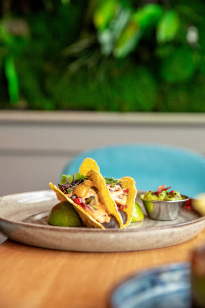 istock vegan taco shells with bean mousse and vegetables and avocado dip on restaurant table 1584631949