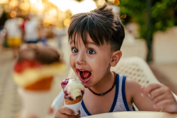 Cute little boy enjoy eating ice cream at summer