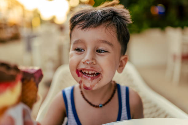 istock Cute little boy enjoy eating ice cream at summer 1584645518