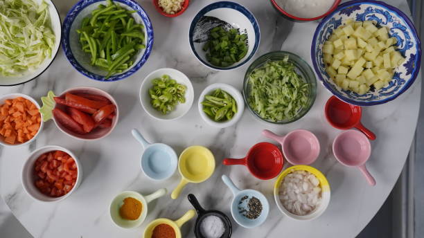 All Ingredients on a white table, yogurt, red and black pepper, chopped onions and tomato and potatoes etc. All Ingredients on a white table, yogurt, red and black pepper, chopped onions and tomato and potatoes etc. cabbage coral photos stock pictures, royalty-free photos & images