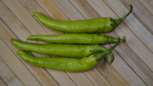 istock Side view of green chilli on a beautiful mat. 1584660972