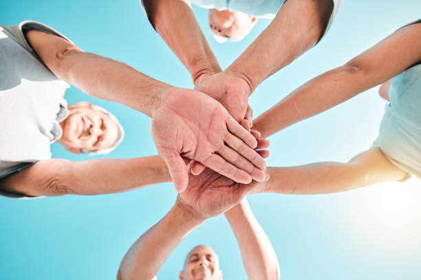 istock Group, hands stacked and teamwork by people in unity, support and collaboration together for a goal. Motivation, trust and team planning a goal, mission or vision in a community in solidarity 1584669203