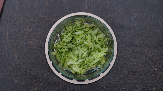 A bowl of cucumber cabbage. Top front view