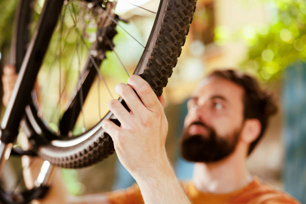 istock Person grasping bicycle tire rubber 1584677357