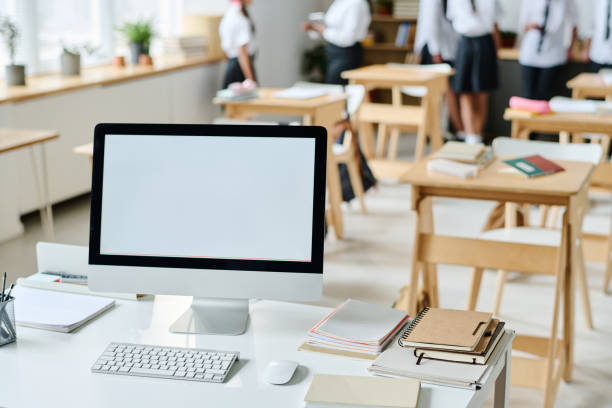 istock Workplace of teacher with computer in classroom 1584678514