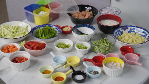 All Ingredients on a white table, yogurt, red and black pepper, chopped onions and tomato and potatoes etc. All Ingredients on a white table, yogurt, red and black pepper, chopped onions and tomato and potatoes etc. cabbage coral photos stock pictures, royalty-free photos & images