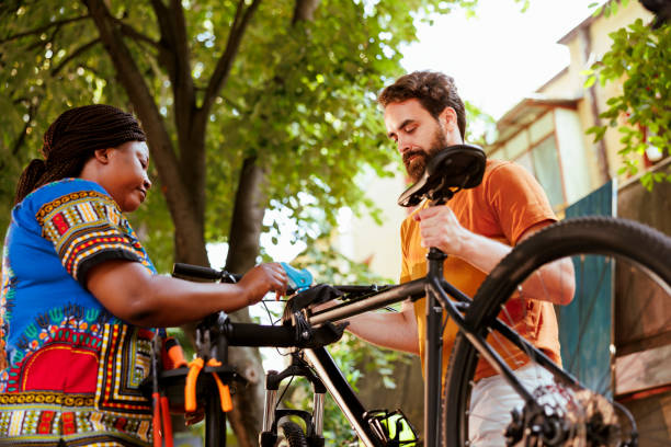 istock Couple fastening bicycle for repair 1584679632