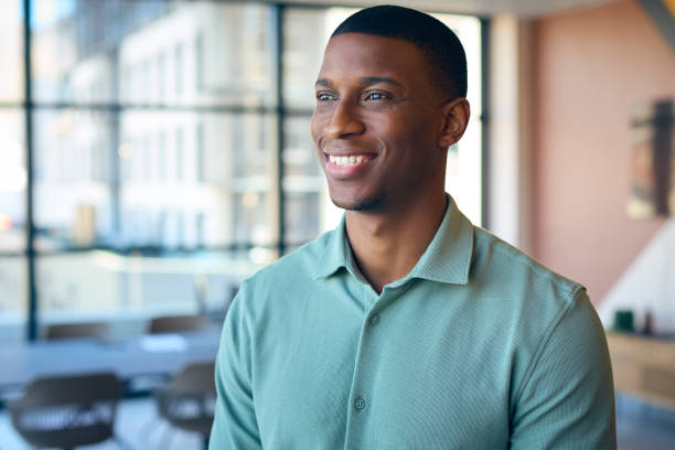 istock Portrait Of Smiling Businessman Standing In Empty Office 1584682376