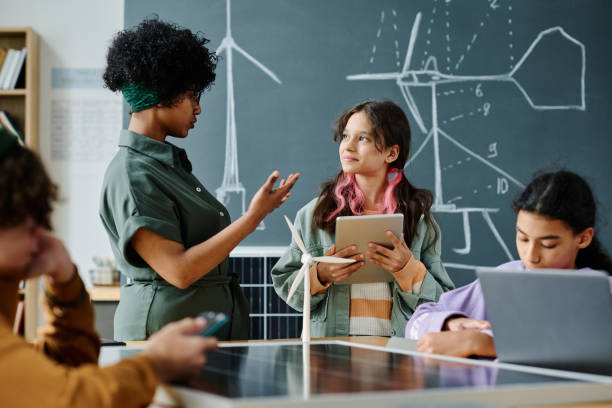 istock Teacher talking to students at lesson 1584683172