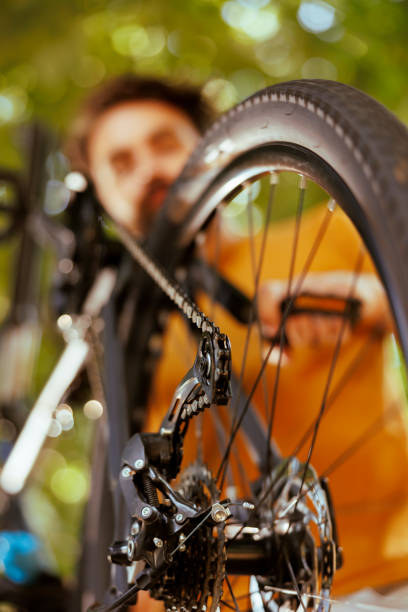istock Bicycle parts being repaired in yard 1584683383