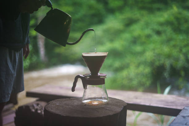 istock Closeup of hands make coffee in home 1584689491