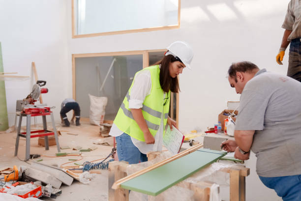 istock The female engineer is talking with the workers at the construction site. 1584709354