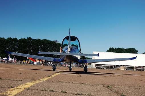 Light-engine training aircraft on the runway. Back view.