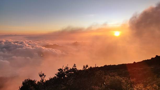 istock sunset over the mountains with orange clouds. 1584712513