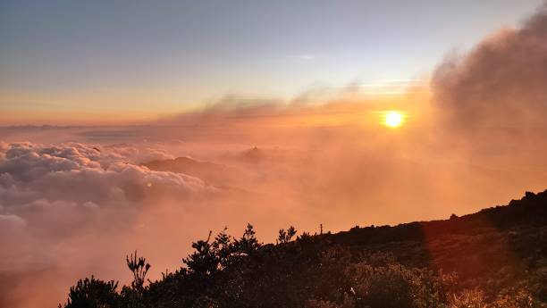 istock sunset over the mountains with orange clouds. 1584712526