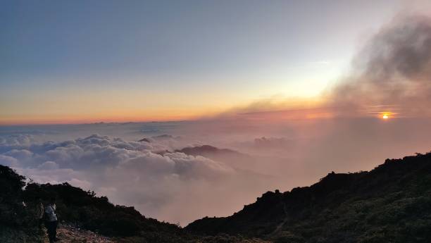 istock sunset over the mountains with orange clouds. 1584712557