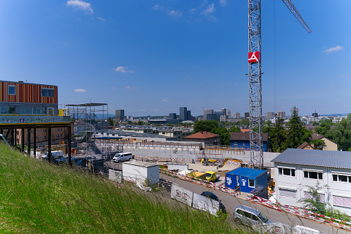 Highway enclosure construction site with cranes and construction workers at City of Zürich on a sunny spring day. Photo taken May 26th, 2023, Zurich, Switzerland.