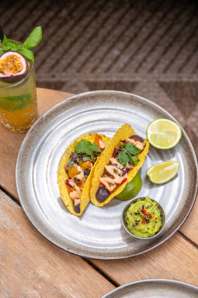 istock vegan taco shells with bean mousse and vegetables and avocado dip on restaurant table 1584715909