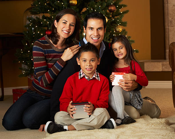 istock Family In Front Of Christmas Tree 158472564