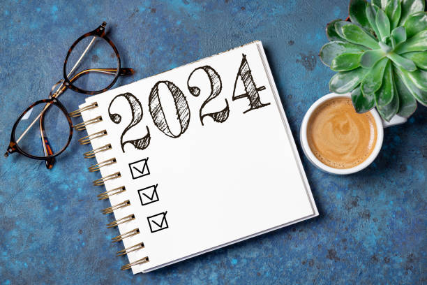 istock New year resolutions 2024 on desk. 2024 resolutions list with notebook, coffee cup on table. Goals, resolutions, plan, action, checklist concept. New Year 2024 template 1584729954