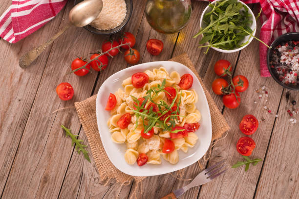 istock Orecchiette pasta with arugula and tomato. 1584739178