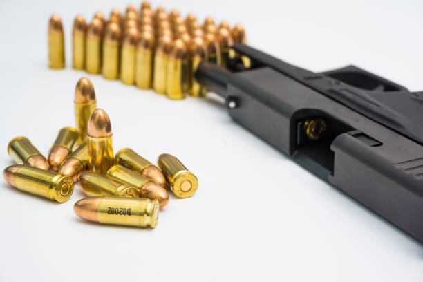 istock 9mm automatic micro sompact pistol with bullet on white background 1584753204