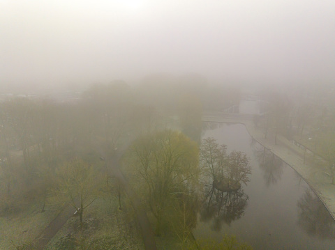 Kampen city park aerial view seen from above during foggy winter morning. Kampen is an ancient Hanseatic League city at the shore of the river IJssel in Overijssel, The Netherlands.