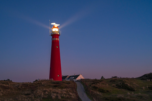 The photo shows the Amrum lighthouse in the dunes