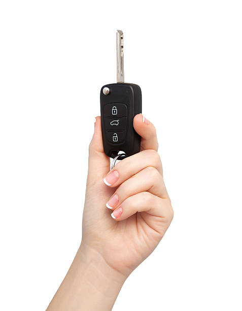 woman hand on isolated background holding car key stock photo