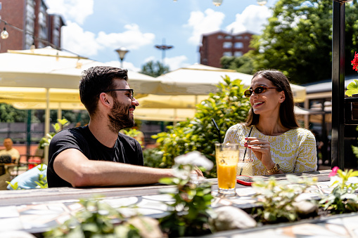 Love blossoms in the tranquil setting of the cafe garden as the couple savors intimate moments together, embracing the serenity and charm of the surroundings
