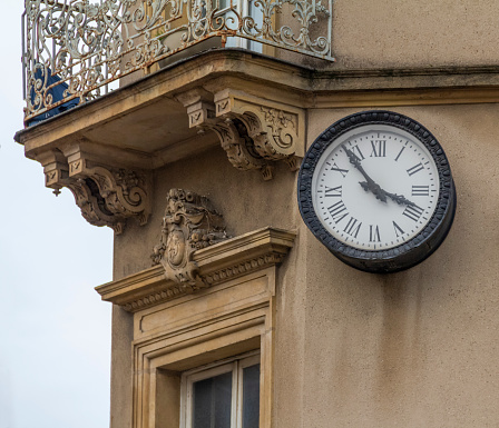 Historic architectural detail with clock and balcony seen in Metz, a city in the Lorraine region in France