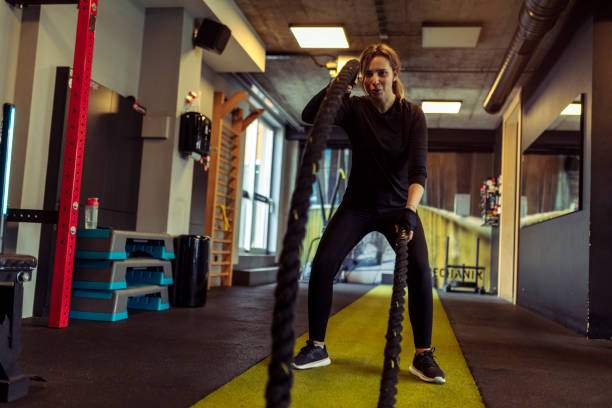 istock A woman trains with a rope, exercises her arms and does cardio training 1584810984