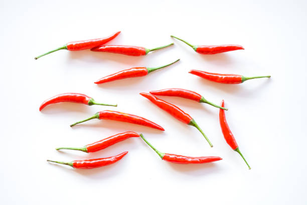 istock Red chili peppers arrange on white background 1584823514