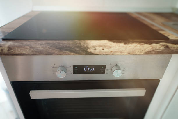 istock Modern electric stove with induction cooktop. 1584852459